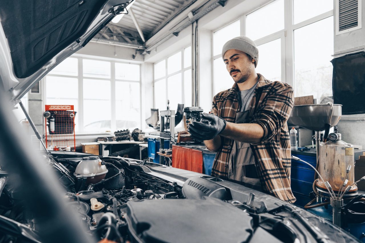 mechanic-examining-car-in-auto-car-repair-service-center-1.jpg
